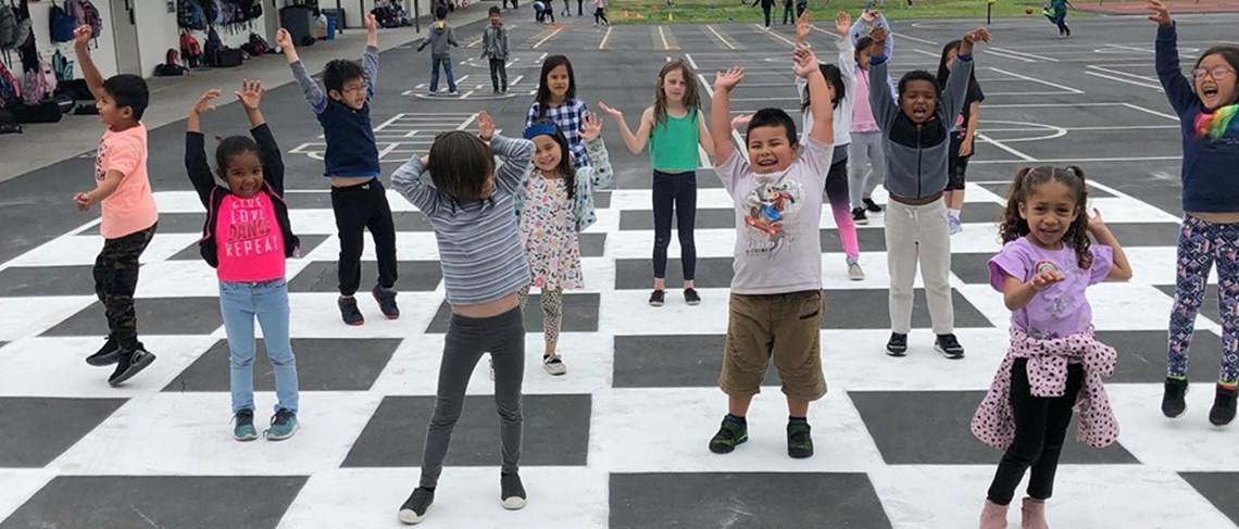 Students enjoying their new life size checker and chess board. Yahoo!