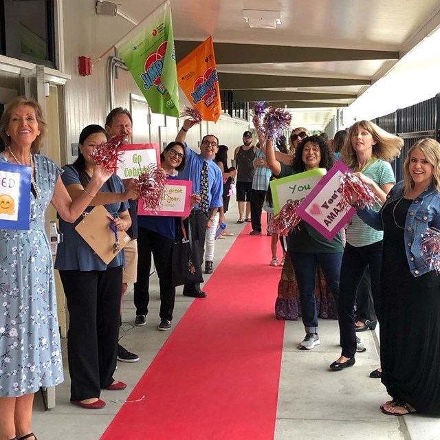 Teachers and staff giving students a red carpet welcome back on their first day