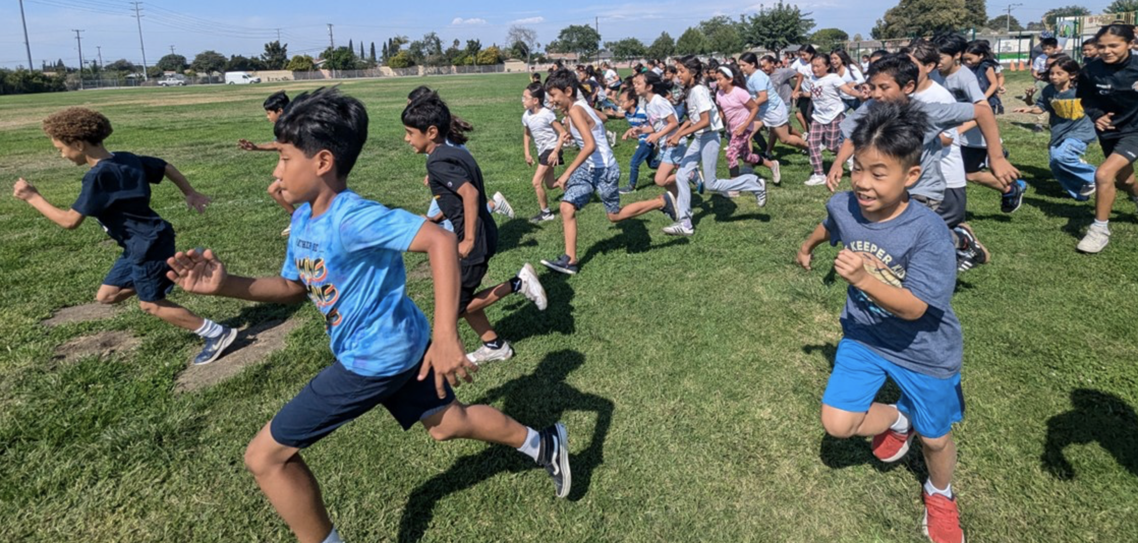 Upper grade students running in a field for the Big Run