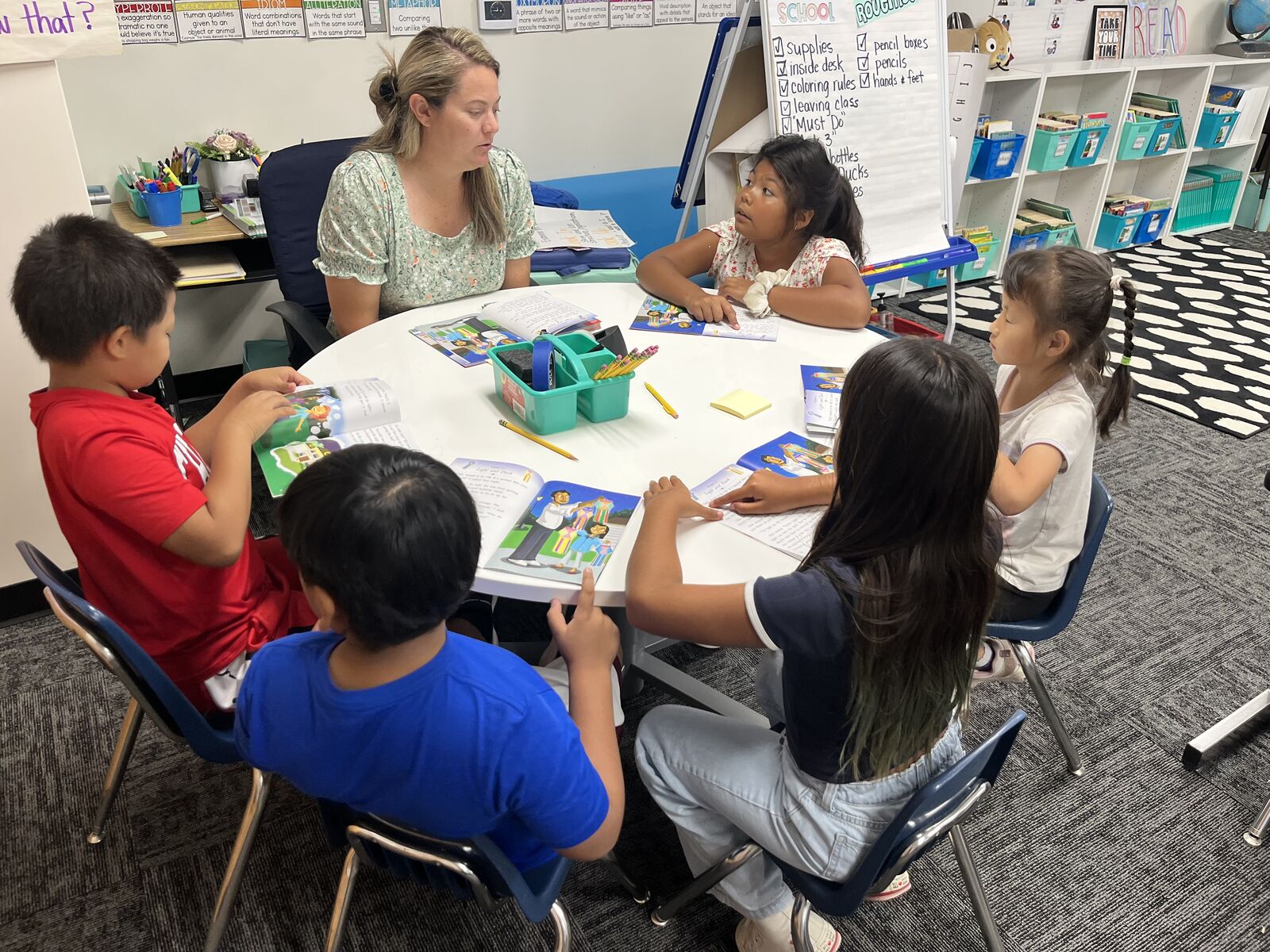 Students sitting at a table with their teacher