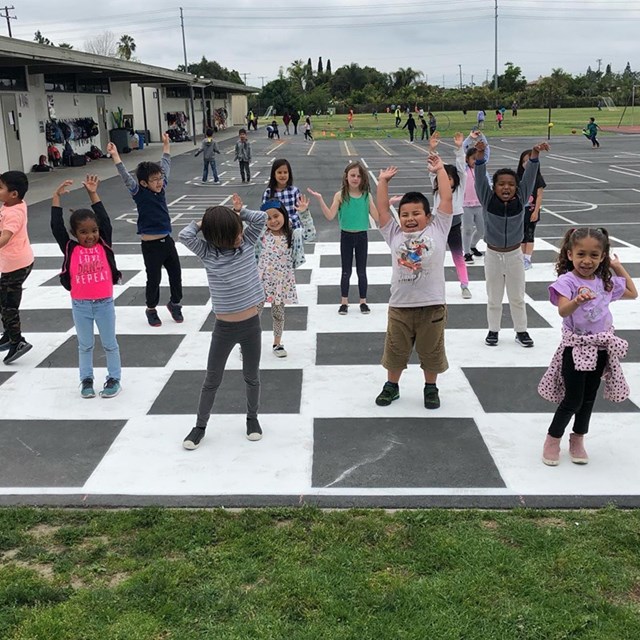 Students enjoying their new life size checker and chess board. Yahoo!